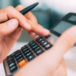 Male hands using calculator_tone